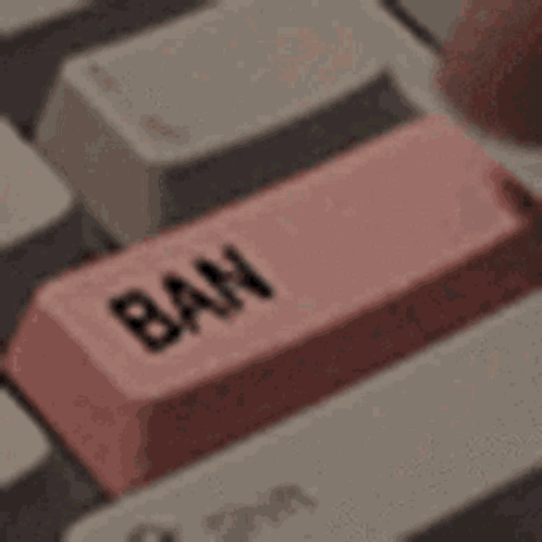 A Close Up Of A Keyboard With A Pink Button That Says Ban . GIF