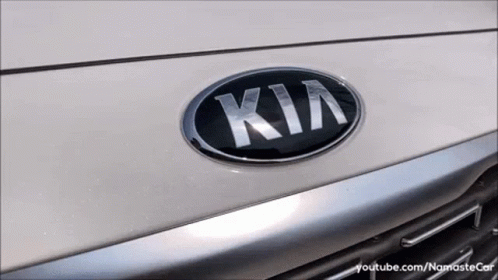 A Close Up Of A Kia Emblem On The Front Of A Car GIF