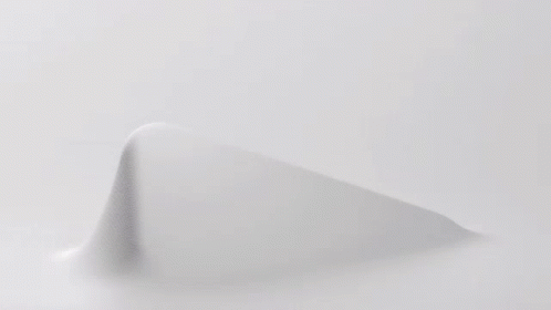 A Close Up Of A Knitted Fabric With A Geometric Pattern On It . GIF
