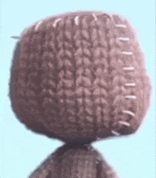 A Close Up Of A Knitted Object With White Stitching On It GIF