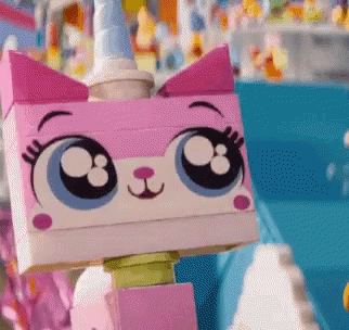 A Close Up Of A Lego Cat With Big Eyes And A Unicorn Horn GIF