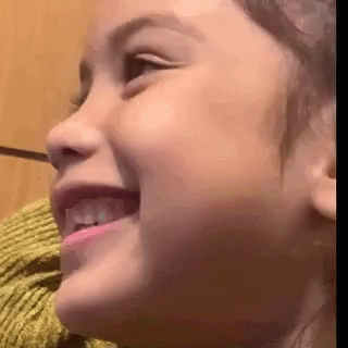 A Close Up Of A Little Girl 'S Face Smiling GIF
