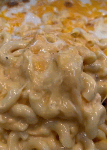 A Close Up Of A Macaroni And Cheese Casserole Dish GIF