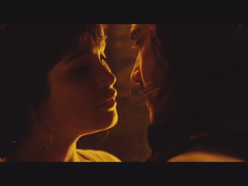 A Close Up Of A Man And Woman Kissing GIF