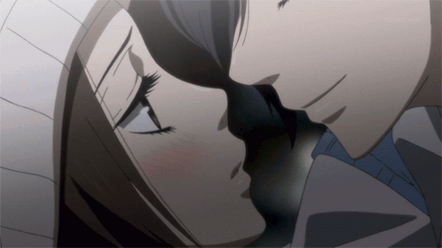 A Close Up Of A Man And Woman Kissing In A Dark Room GIF