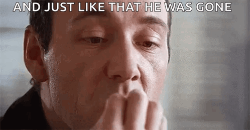 A Close Up Of A Man Covering His Mouth With His Hand And A Caption That Says `` And Just Like That He Was Gone '' . GIF