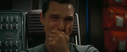 A Close Up Of A Man Covering His Mouth With His Hand . GIF