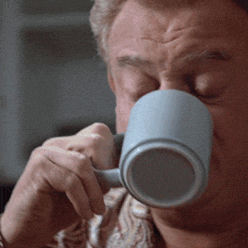 A Close Up Of A Man Drinking From A Mug GIF