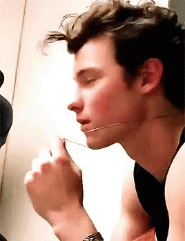 A Close Up Of A Man Eating A Piece Of Food With A Fork . GIF