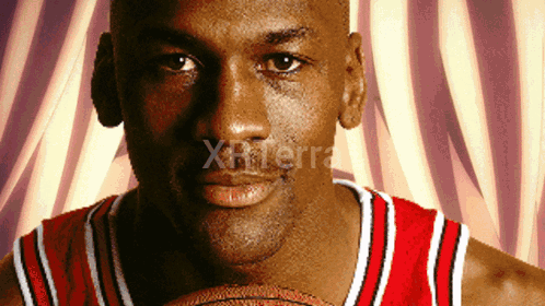 A Close Up Of A Man Holding A Basketball With The Word Xterra On The Bottom Right GIF
