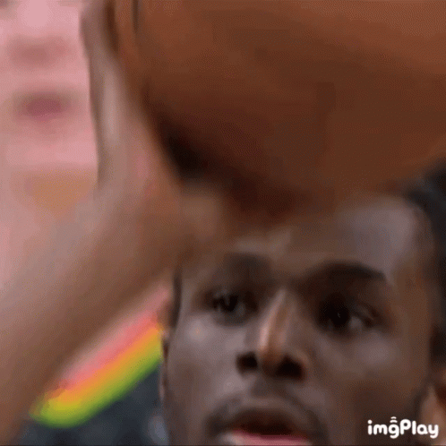 A Close Up Of A Man Holding A Basketball With The Words Imgplay Below GIF