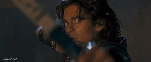 A Close Up Of A Man Holding A Bow And Arrow With Illusive Soul Written On The Bottom GIF