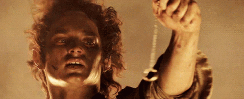 A Close Up Of A Man Holding A Key GIF