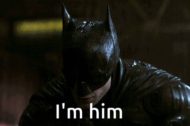 A Close Up Of A Man In A Batman Costume With The Words I 'M Him Below Him GIF