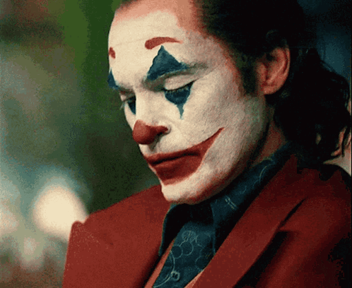 A Close Up Of A Man In A Clown Costume GIF