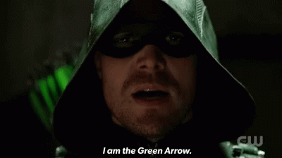 A Close Up Of A Man In A Green Hood Saying " I Am The Green Arrow " GIF