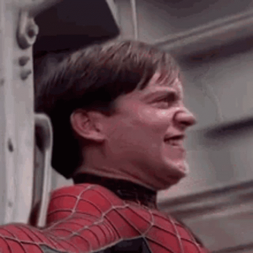 A Close Up Of A Man In A Spiderman Costume Leaning Against A Wall . GIF