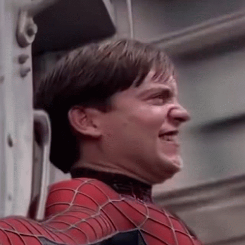 A Close Up Of A Man In A Spiderman Suit Making A Face . GIF