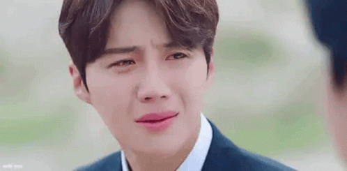 A Close Up Of A Man In A Suit And Tie Crying With His Eyes Closed . GIF