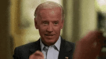 A Close Up Of A Man In A Suit And Tie Giving A Thumbs Up . GIF