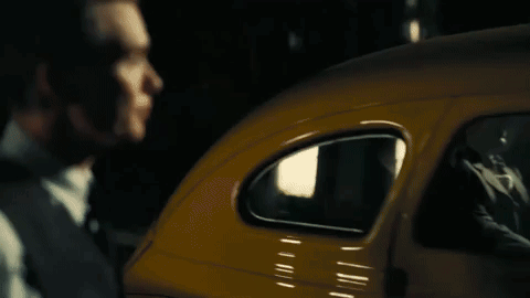 A Close Up Of A Man In A Suit And Tie Looking Down . GIF