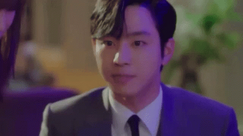A Close Up Of A Man In A Suit And Tie Making A Face . GIF