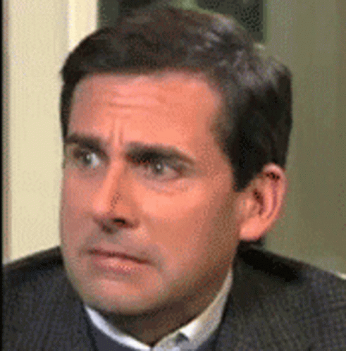 A Close Up Of A Man In A Suit And Tie Making A Funny Face . GIF