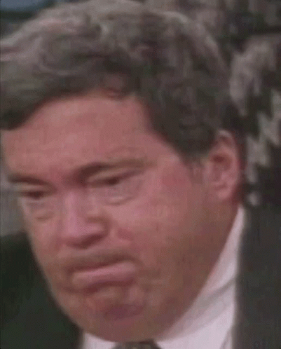 A Close Up Of A Man In A Suit And Tie With A Serious Look On His Face . GIF