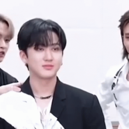 A Close Up Of A Man In A Suit Standing Next To Another Man . GIF