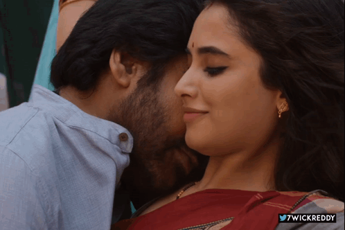 A Close Up Of A Man Kissing A Woman With The Hashtag 7Wickreddy On The Bottom GIF