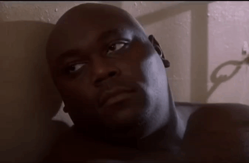 A Close Up Of A Man Laying On A Bed GIF