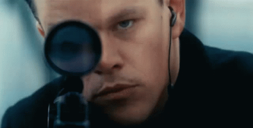 A Close Up Of A Man Looking Through A Scope . GIF