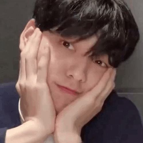 A Close Up Of A Man Making A Face With His Hands On His Face . GIF
