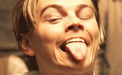 A Close Up Of A Man Making A Face With His Tongue Out GIF