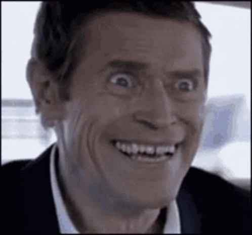 A Close Up Of A Man Making A Funny Face While Smiling . GIF