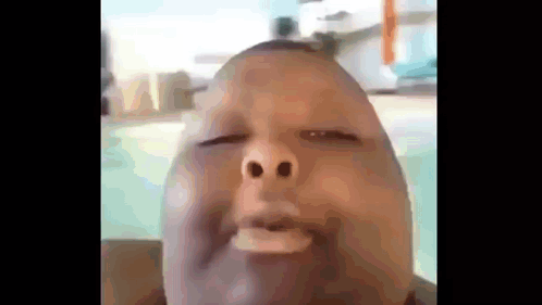 A Close Up Of A Man Making A Funny Face With His Eyes Closed GIF