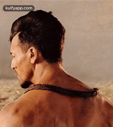 A Close Up Of A Man 'S Back With A Rope Around It . GIF