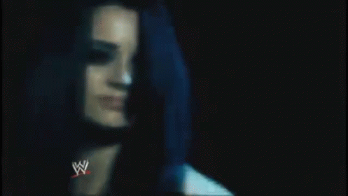 A Close Up Of A Man 'S Chest With A Wrestling Logo On It . GIF