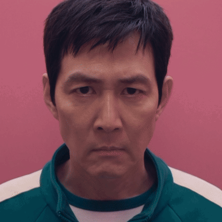 A Close Up Of A Man 'S Face Against A Pink Wall GIF