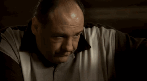 A Close Up Of A Man 'S Face And Arm With A Bandage On His Wrist . GIF