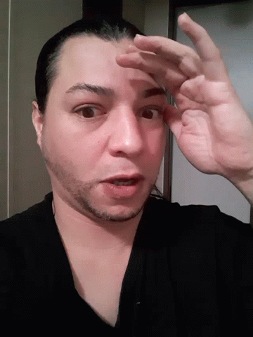 A Close Up Of A Man 'S Face And Hands GIF