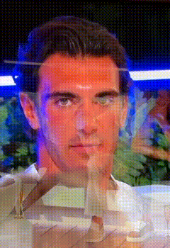 A Close Up Of A Man 'S Face Behind A Glass Covering GIF