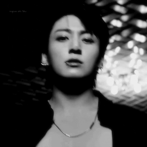 A Close Up Of A Man 'S Face In A Black And White Photo . GIF
