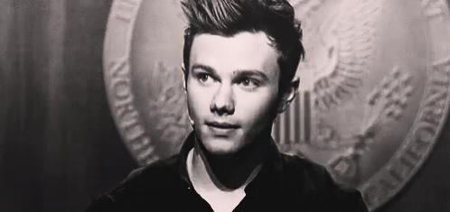 A Close Up Of A Man 'S Face In A Black And White Photo With A Coin In The Background . GIF