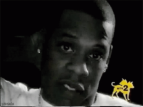 A Close Up Of A Man 'S Face In A Black And White Photo With A Dog In The Background . GIF