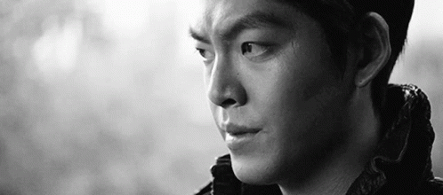 A Close Up Of A Man 'S Face In A Black And White Photo With A Serious Look On His Face . GIF