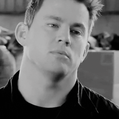 A Close Up Of A Man 'S Face In A Black Shirt GIF