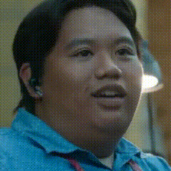 A Close Up Of A Man 'S Face In A Blue Shirt GIF