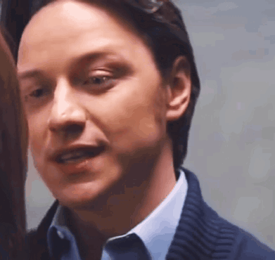 A Close Up Of A Man 'S Face In A Blue Shirt And Blue Sweater . GIF