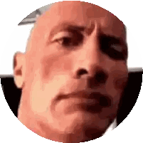 a close up of a man 's face in a circle with a serious look on his face .